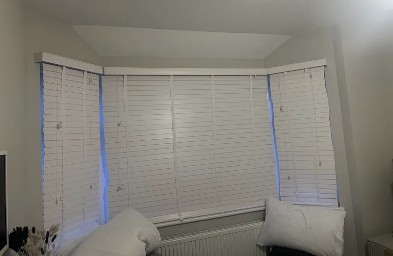 Hang curtains in a bay window with sloping celing